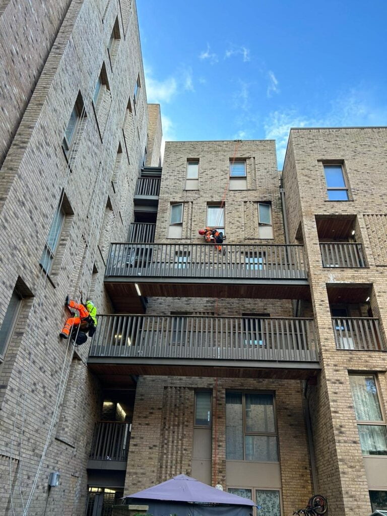 Avisan rope access technicians work on balcony and parapet cleaning repairs maintenance