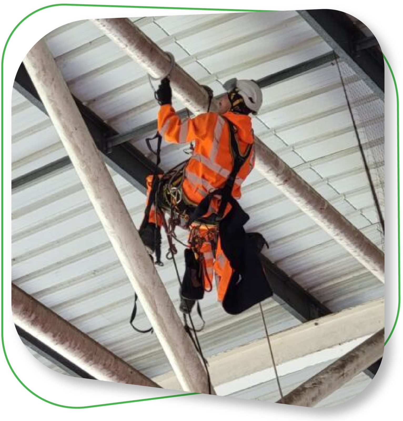 Avisan rope acess technician providing Rope Access Services hanging from beam with safety harness
