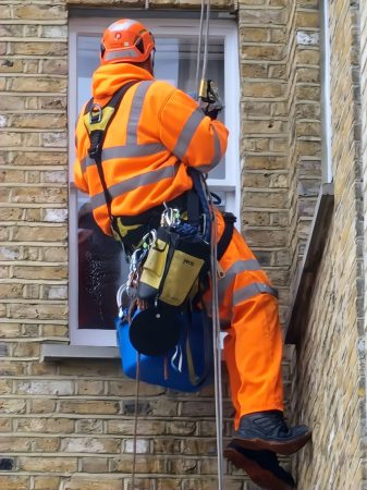 Avisan providing rope access solutions with rope access technician cleaning window