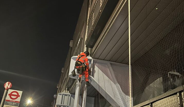 Bird netting being installed by an Avisan rope access technician in Camden Sainsbury's