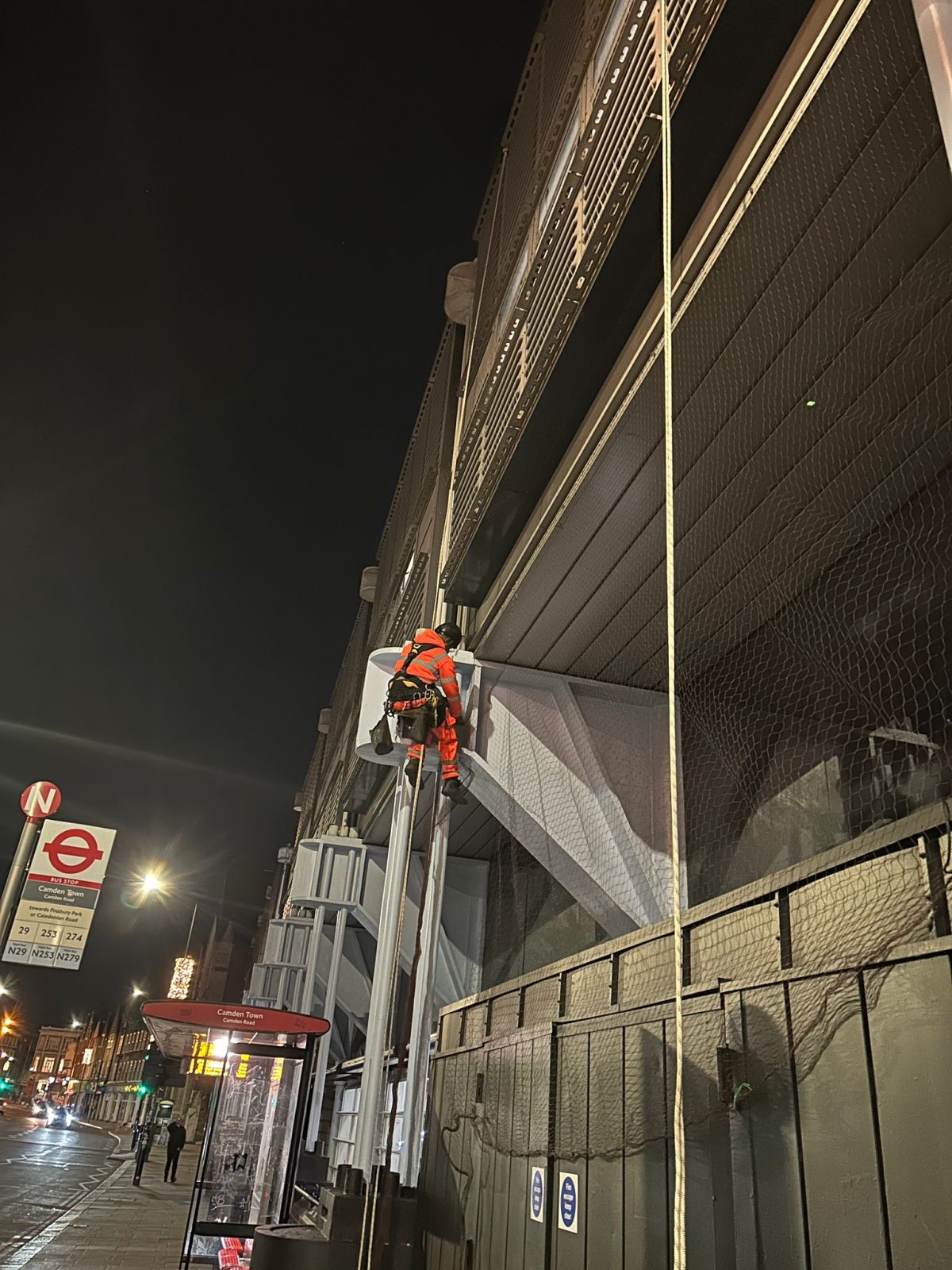 Bird netting being installed by an Avisan rope access technician in Camden Sainsbury's