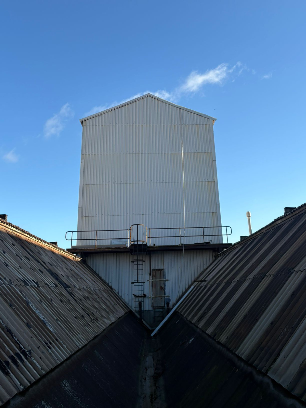 Warehouse rooftop in daylight during rope access in Essex